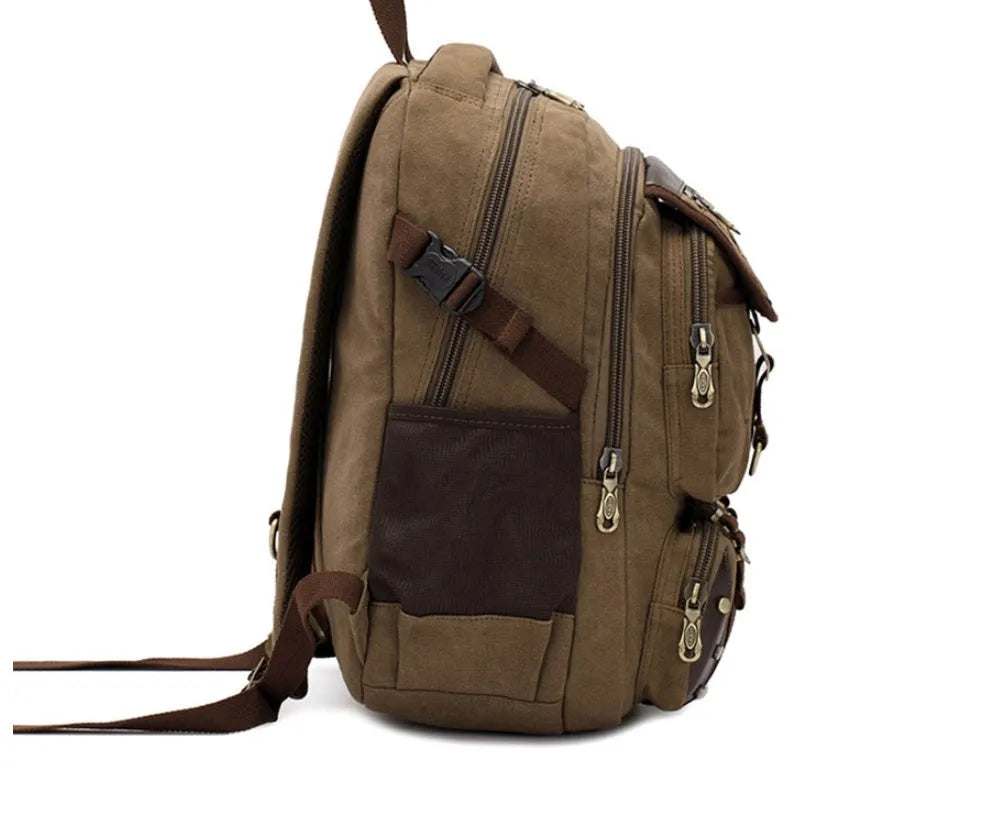 Canvas computer backpack in black with square vertical shape, zip closure, and multiple pockets
