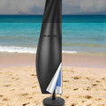 Black outdoor waterproof cover for a banana-shaped patio umbrella on a garden table