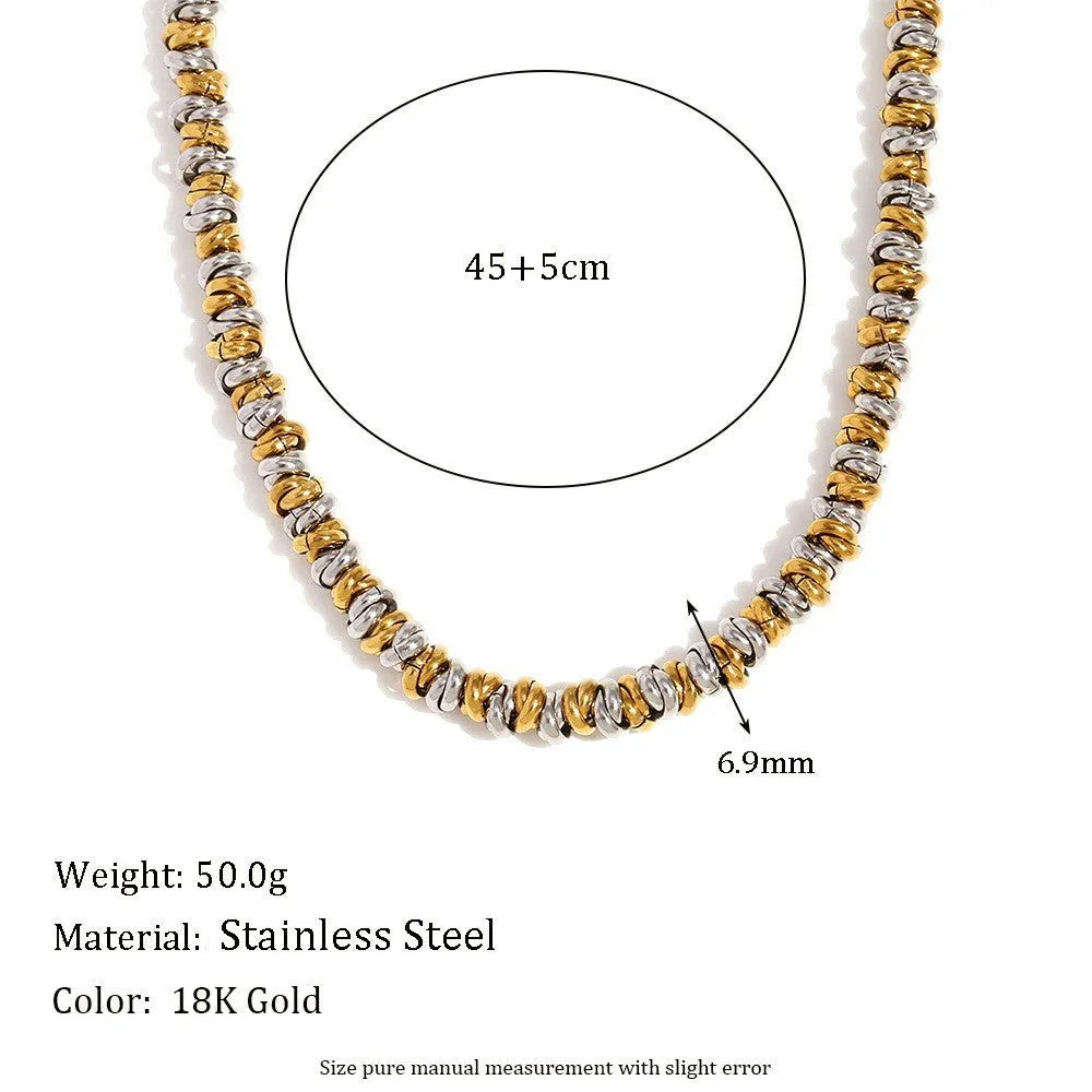 Gold electroplated geometric jewellery set with earrings, bracelet and necklace on white background