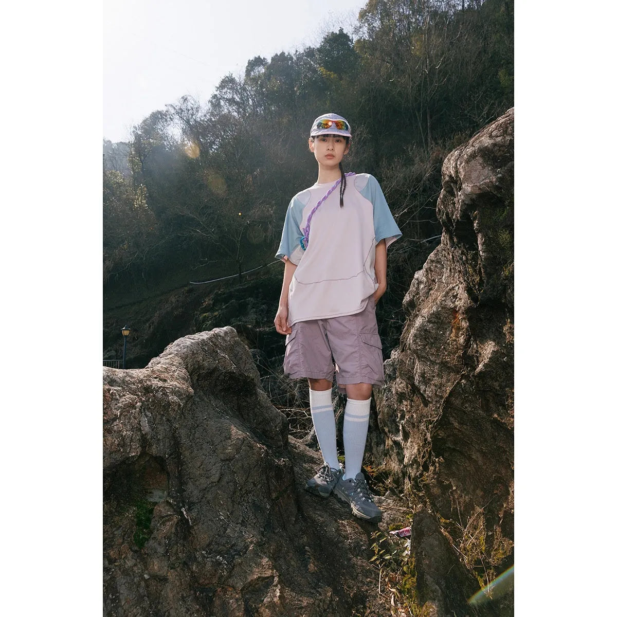Men's loose blue patchwork t-shirt with raglan short sleeves on a mannequin.