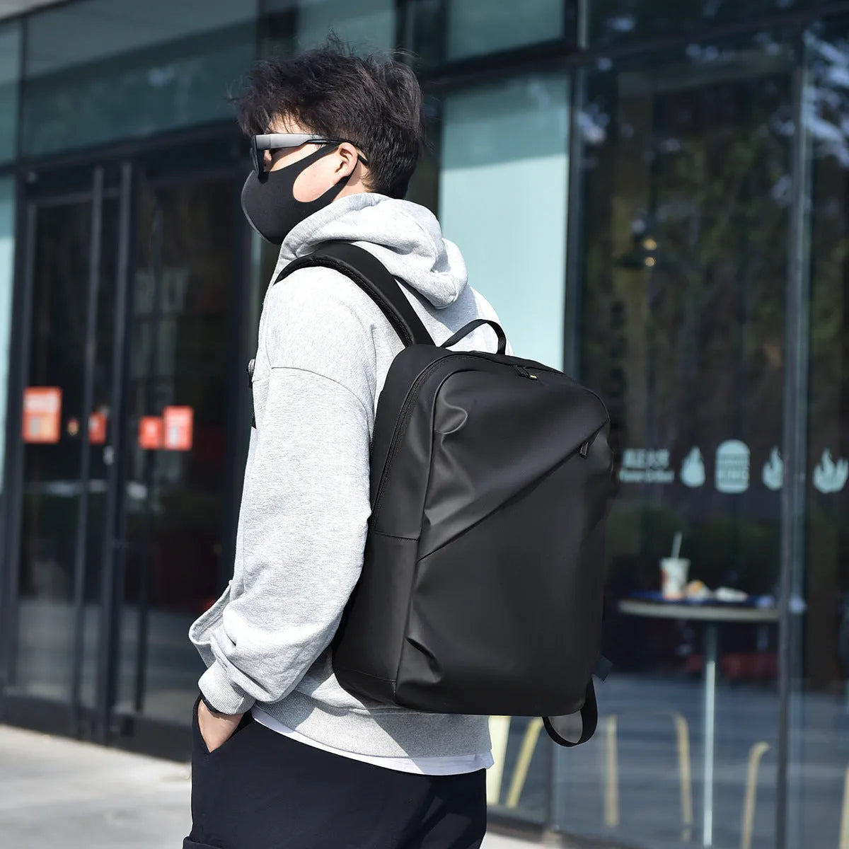 Large black waterproof backpack with 40 litre capacity and PU leather construction