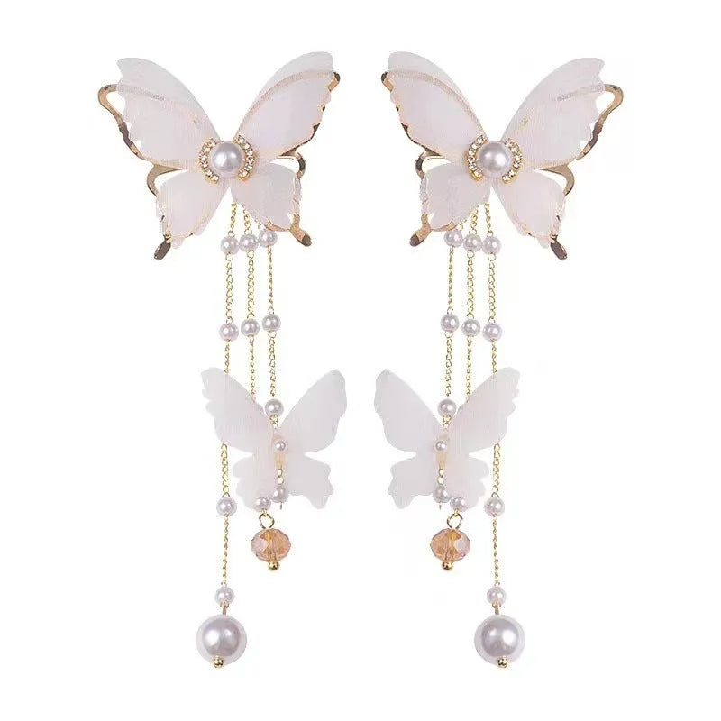 White butterfly earrings with lace details, tassels, rhinestones and pearls on copper alloy