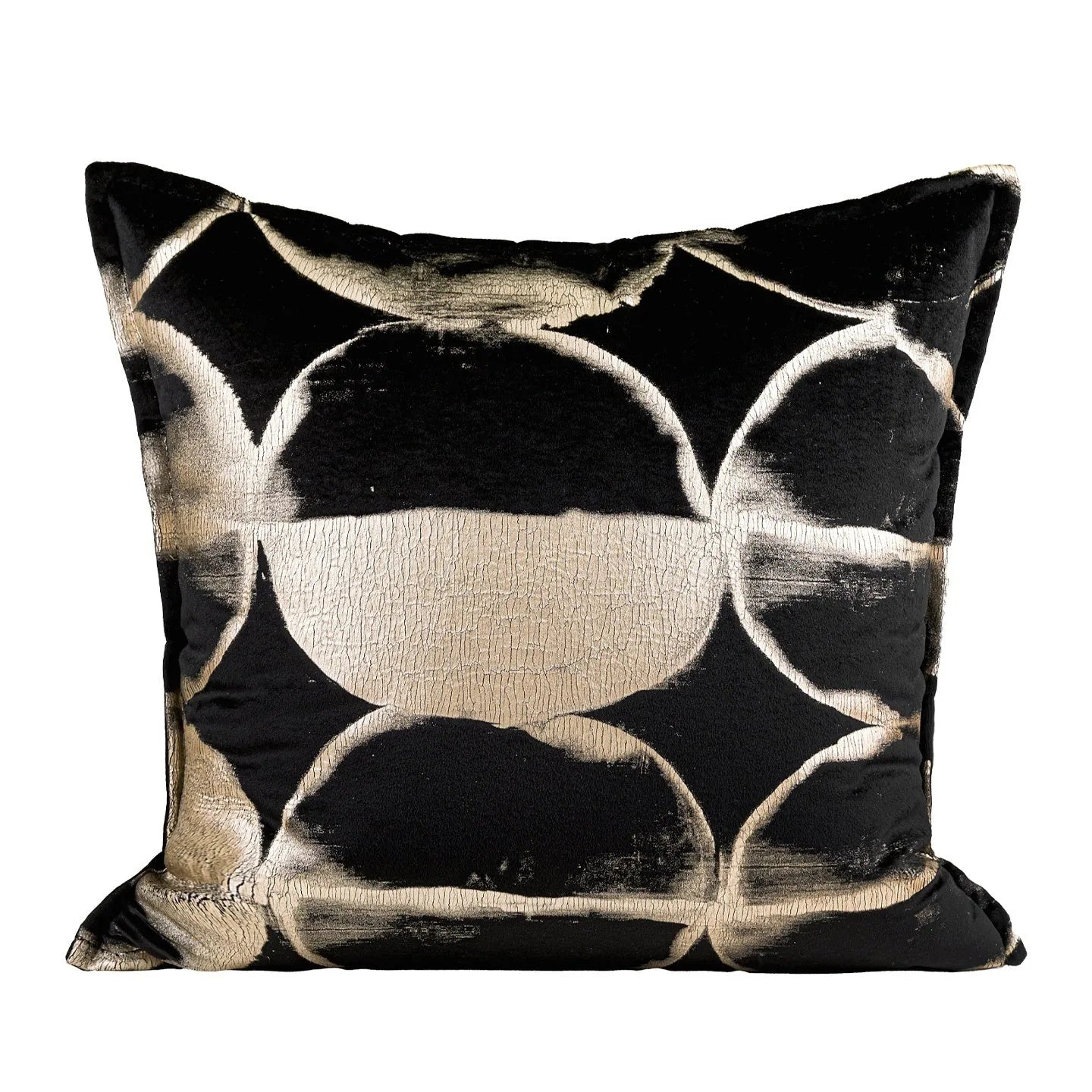 Black and gold abstract print flannel decorative cushion pillow on a sofa.