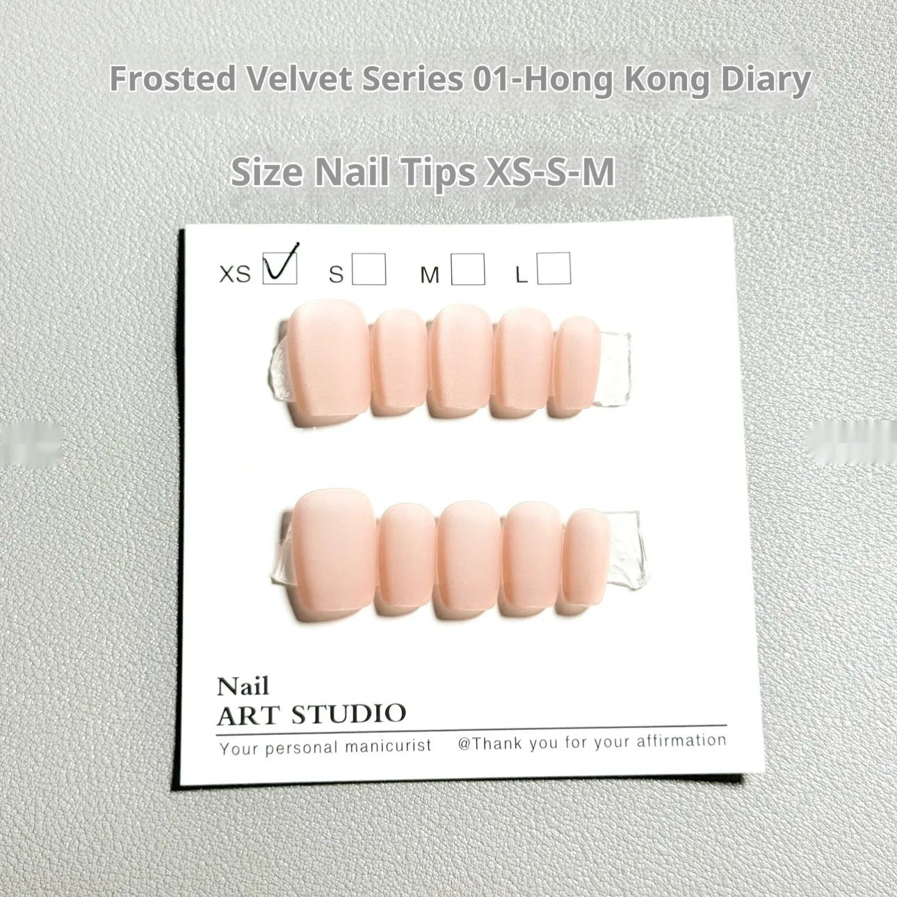 Set of frosted velvet Cat's Eye effect press-on artificial nails in short ladder shapes on a clear background.