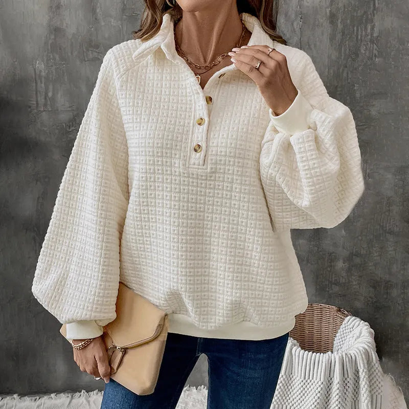 Women's milky white textured polo collar chunky knit sweater laid flat.
