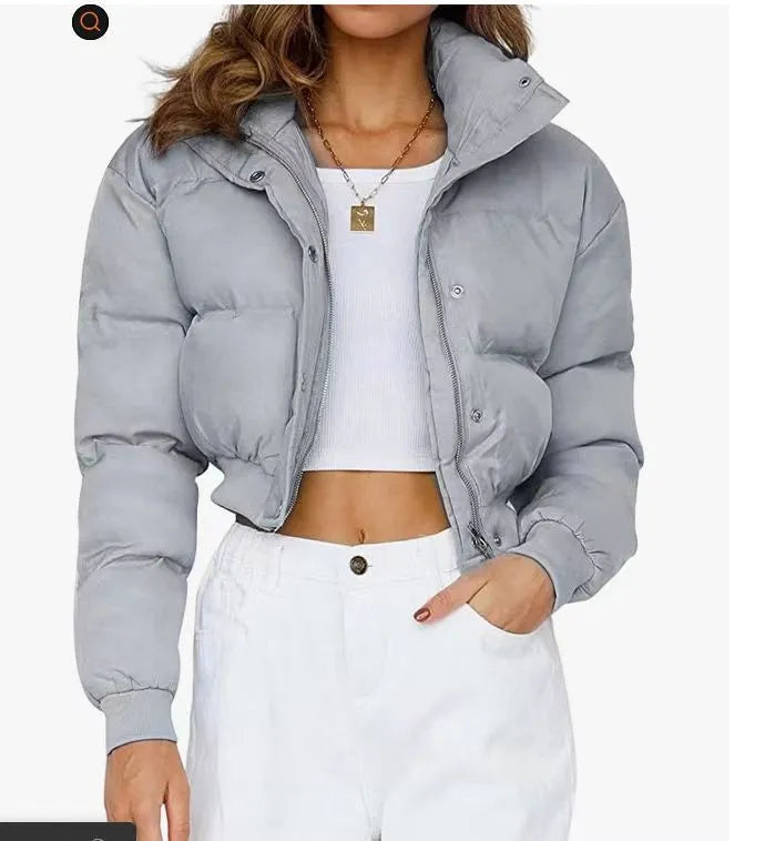 Loose fit blue polyester jacket for women on a hanger, showing long sleeves and front closure.