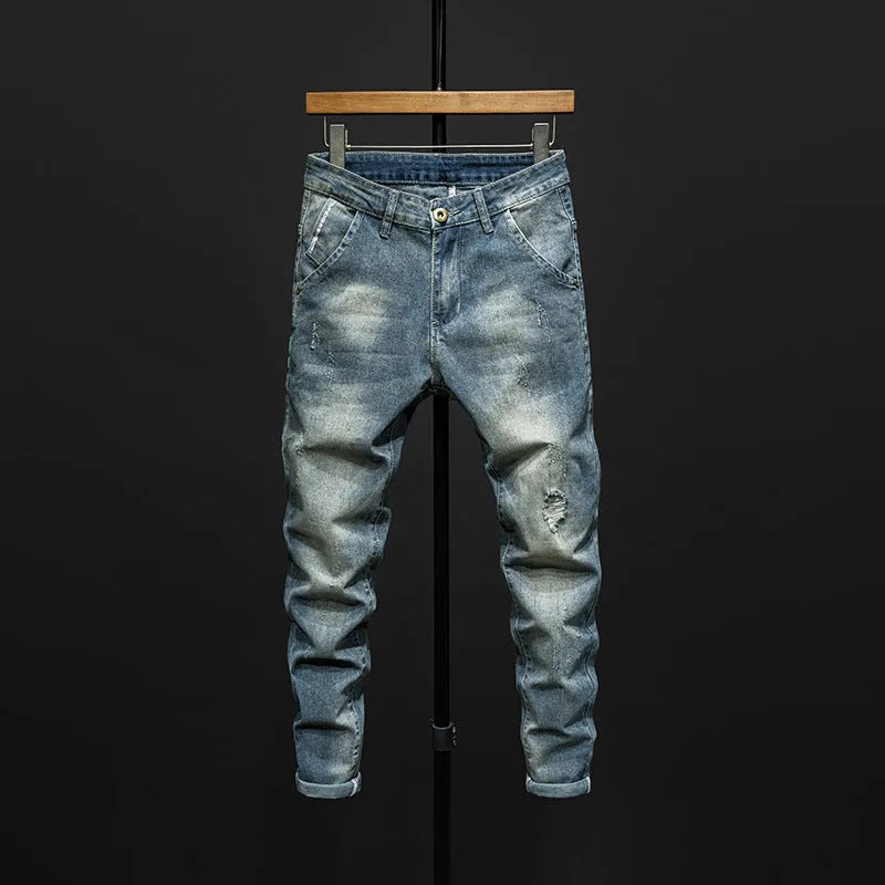 Men's slim-fit skinny jeans in dark blue cotton denim on a hanger.