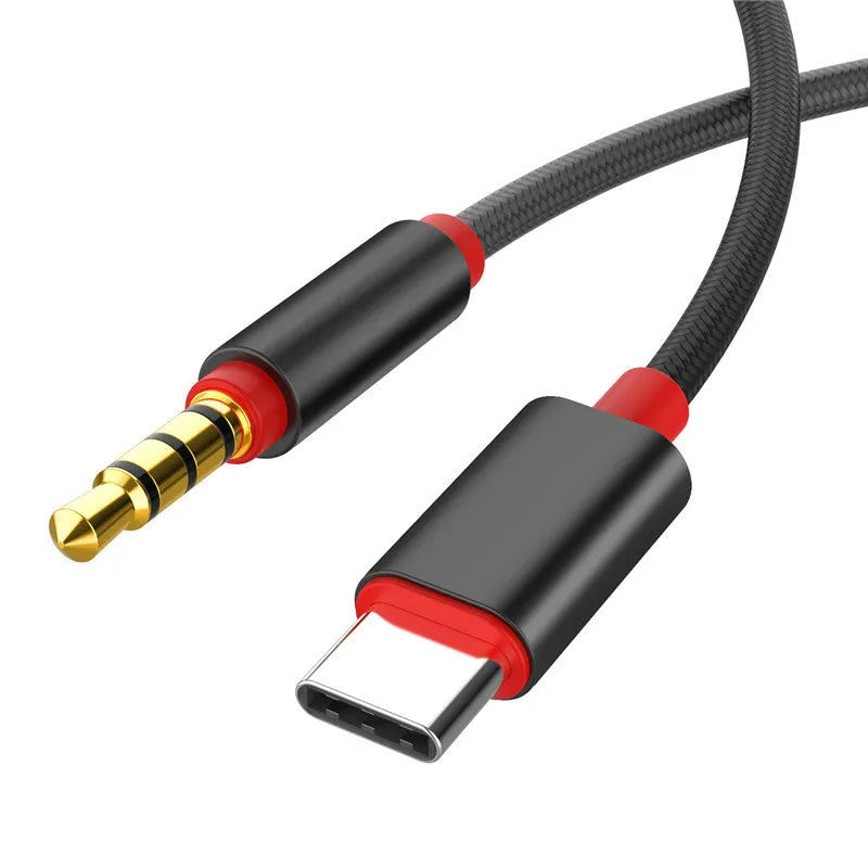 Silver nylon-braided audio cable with 3.5mm connectors on a dark background.