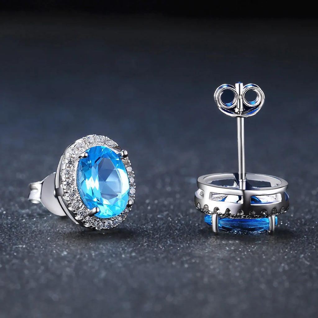 925 sterling silver jewellery set with blue topaz gems showing geometric patterned necklace, earrings, ring and pendant