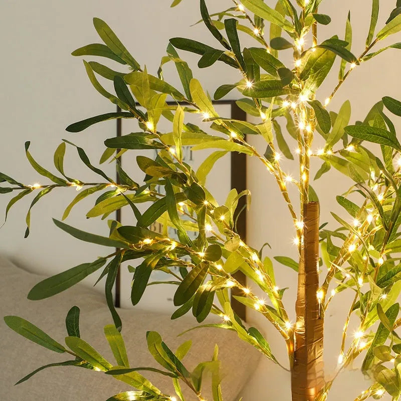 1.8 metre tall artificial olive tree lamp with warm LED lights illuminating courtyard decoration