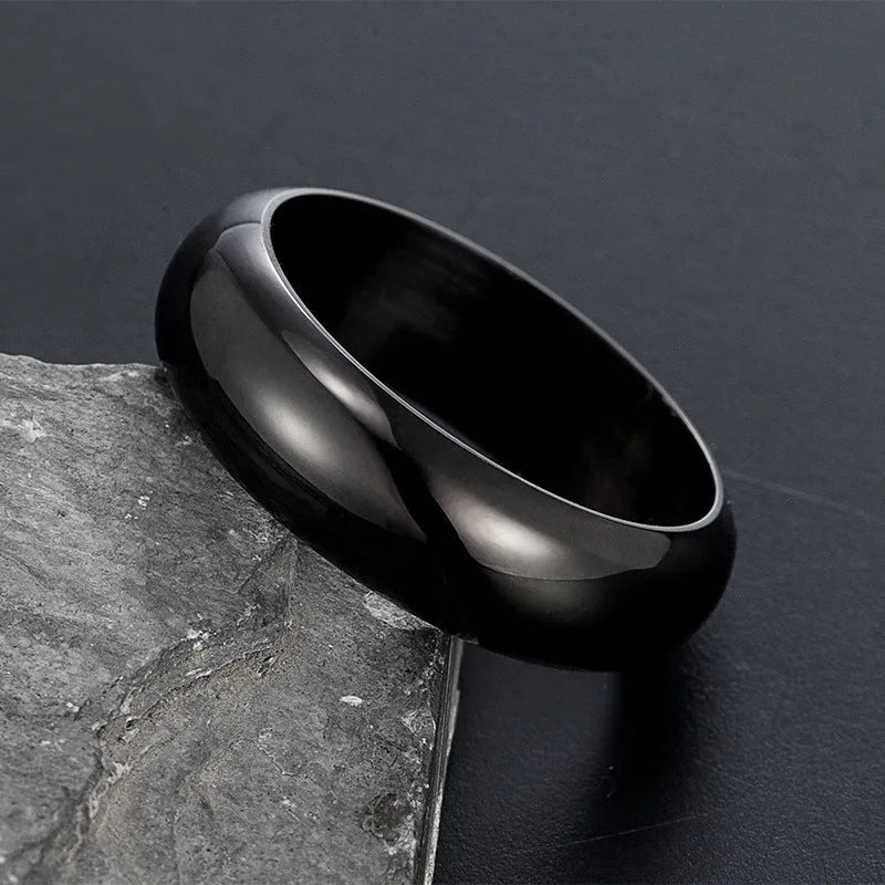 Glossy electroplated titanium steel ring shown in black, gold, and steel colour on a neutral background.