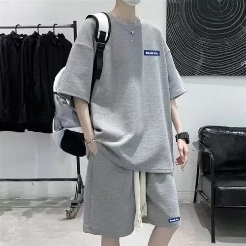 Men's waffle-textured leisure sports suit set with short sleeve top and matching shorts in cotton polyester blend fabric
