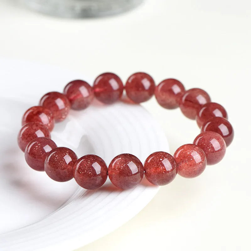 Natural starlight cherry red strawberry quartz bracelet with geometric beads on wrist