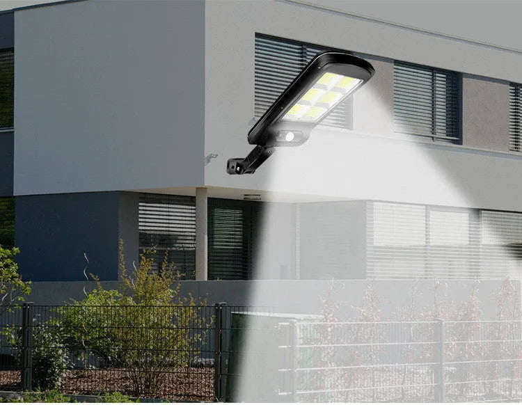 Black solar-powered outdoor wall light with motion sensor for garden and driveway security.