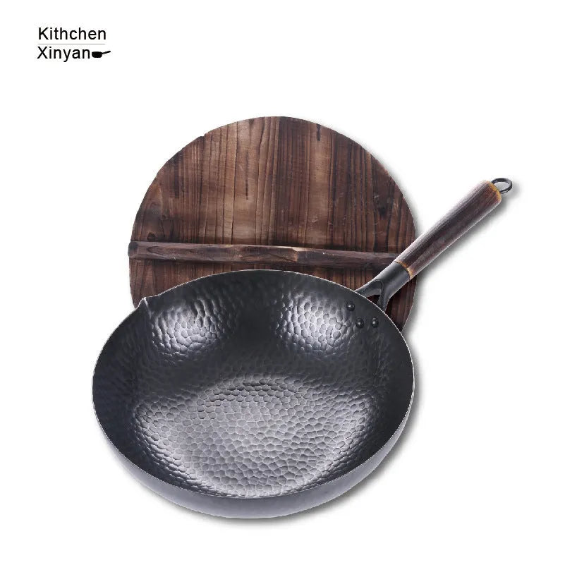 Traditional black iron wok with long wooden handle measuring 32cm diameter