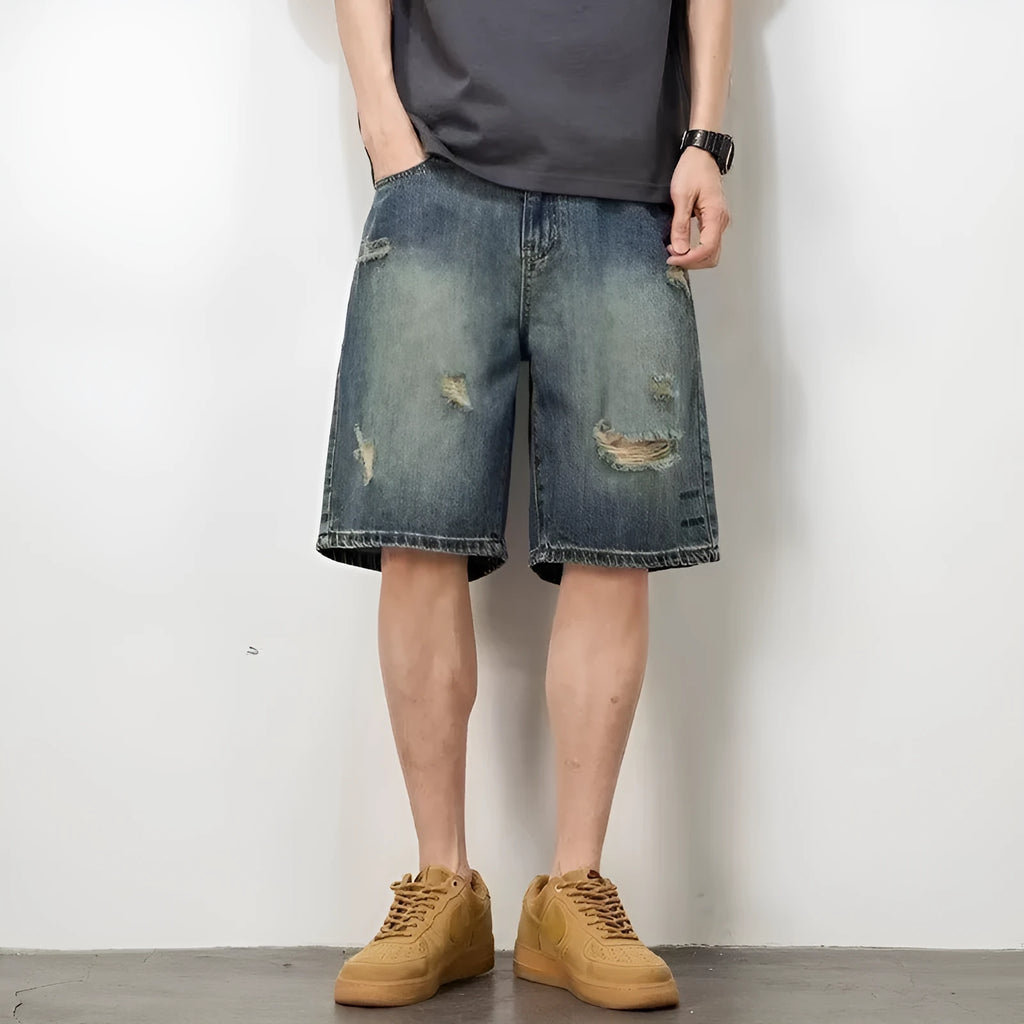 Blue retro loose hole denim shorts for men on a white background