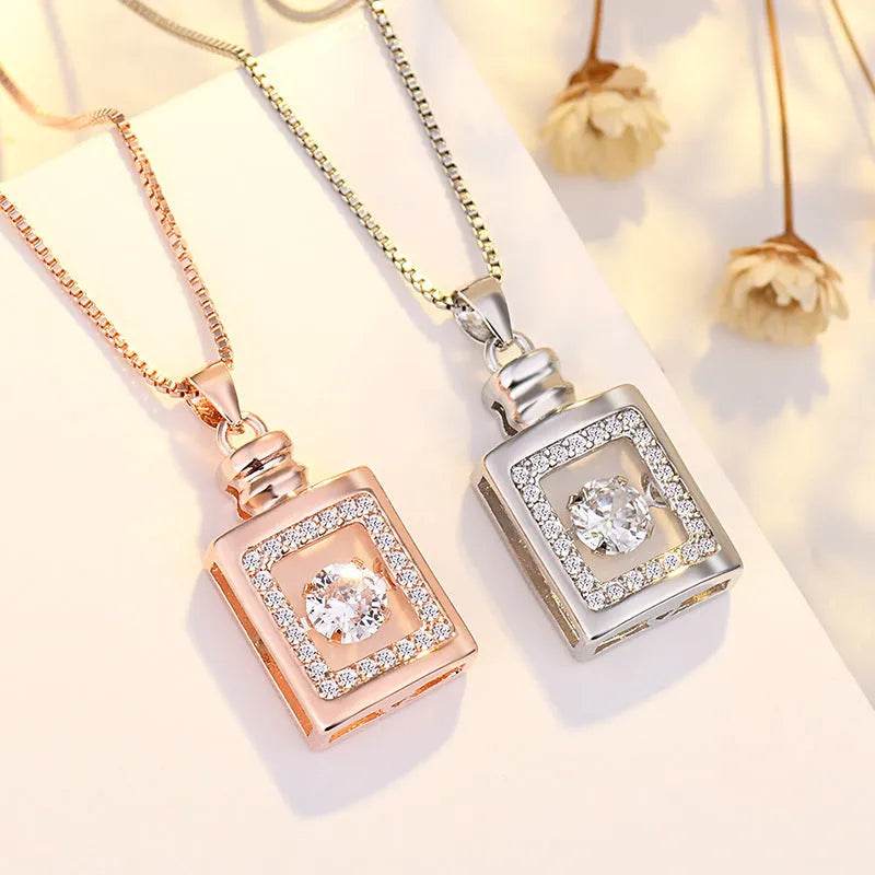 Sterling silver heart necklace with crown and bow decorations in silver and rose gold finishes