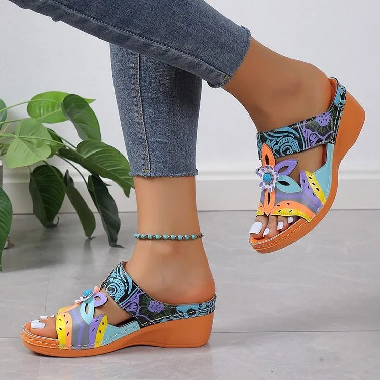Ethnic patterned slippers in purple with a round toe, cowhide upper, and rubber sole.