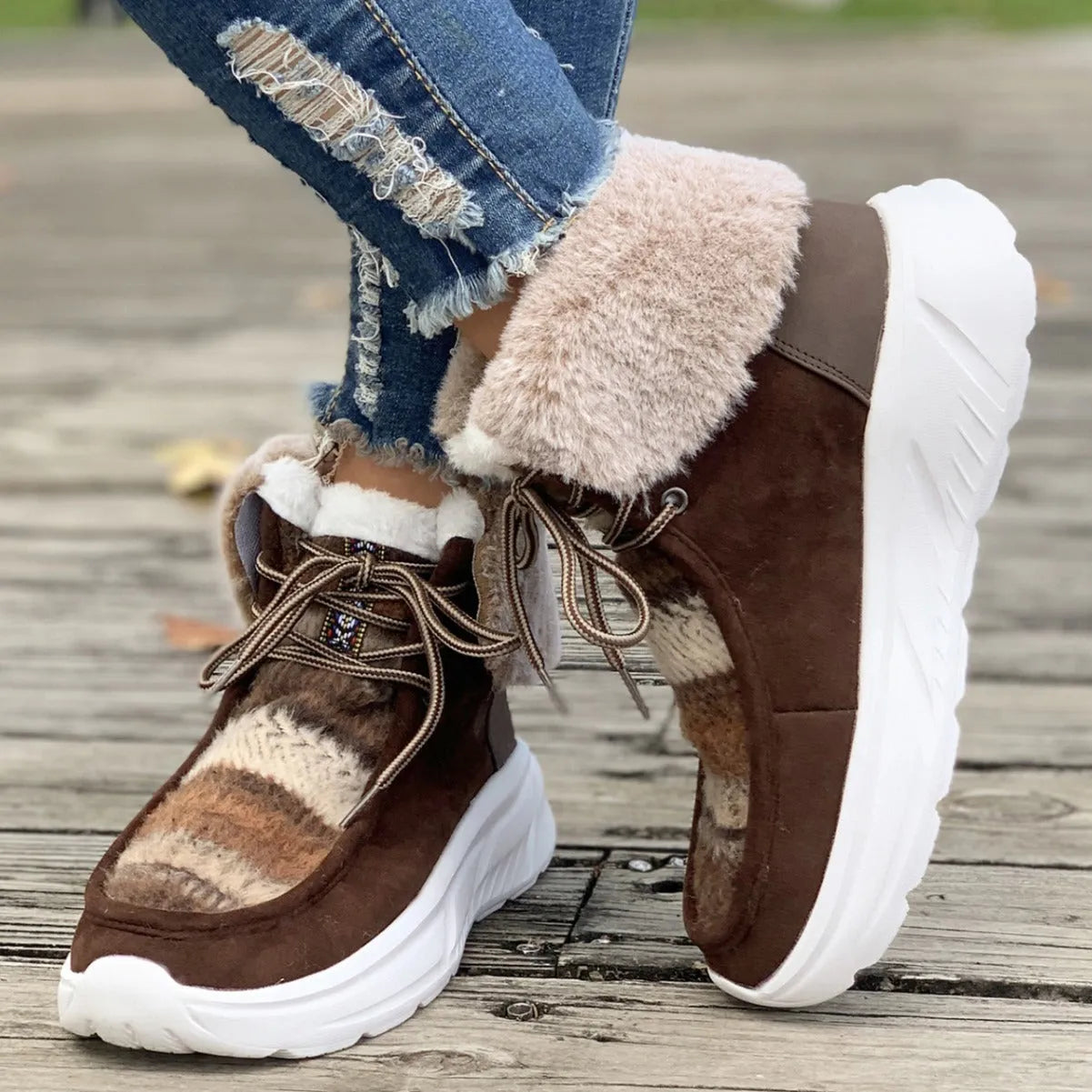 Women's beige lace-up snow boots with suede upper, thick rubber sole, and fuzzy lining on a white background.