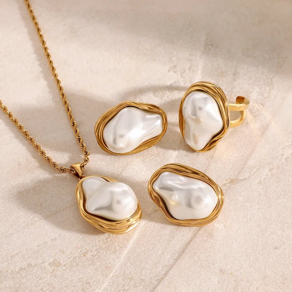 Women's stainless steel necklace with irregular mother pearl shellfish pendant on regular chain, with matching earrings and ring