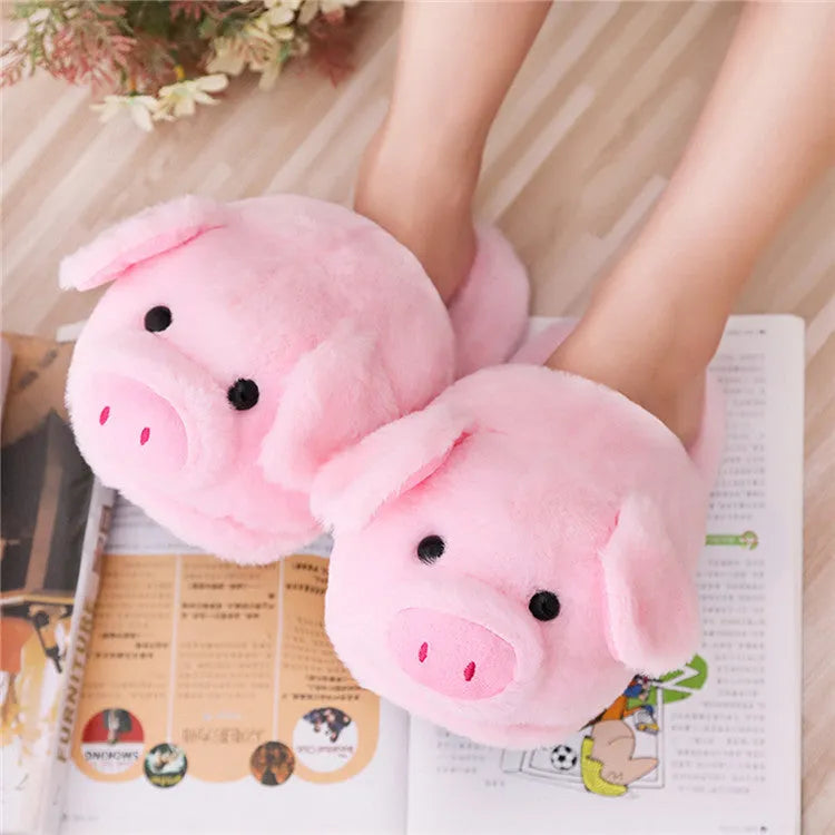 Pink pig-shaped floor slippers with short plush fabric on a plain background.