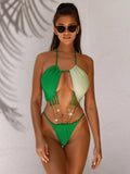 Green women's one-piece swimsuit with hollowed side panels on mannequin