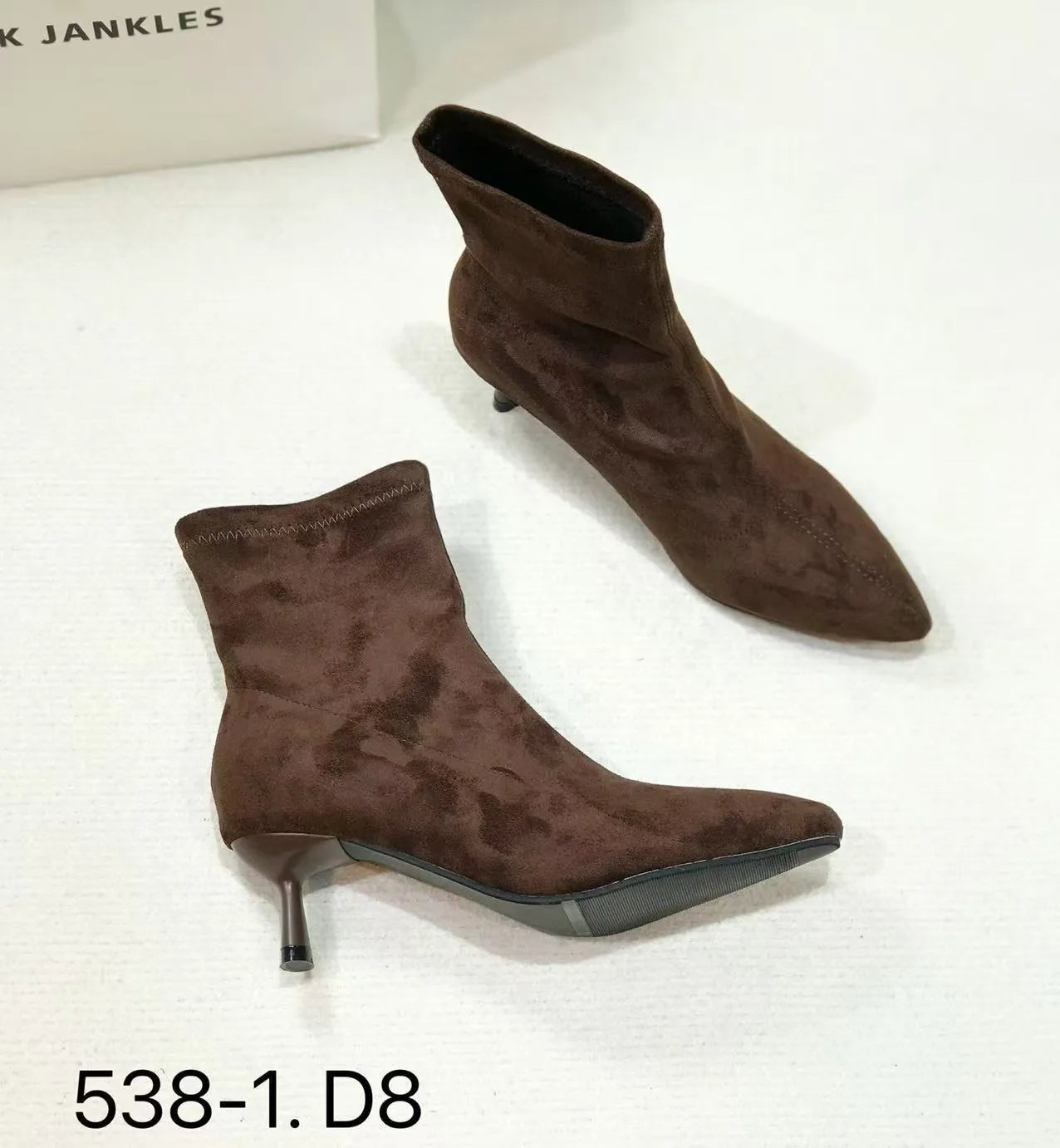 Black pointed toe stiletto heel ankle boots with a calf-high shaft on a neutral background.