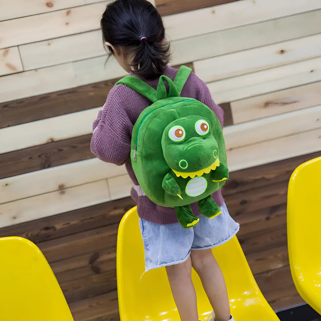 Soft blue dinosaur plush backpack for children with embroidered details and a soft handle.