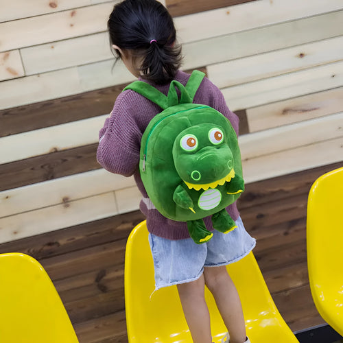 Soft blue dinosaur plush backpack for children with embroidered details and a soft handle.