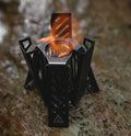 Black hexagon-shaped foldable alcohol camping stove shown with dimensions.