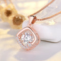 Sterling silver heart necklace with crown and bow decorations in silver and rose gold finishes