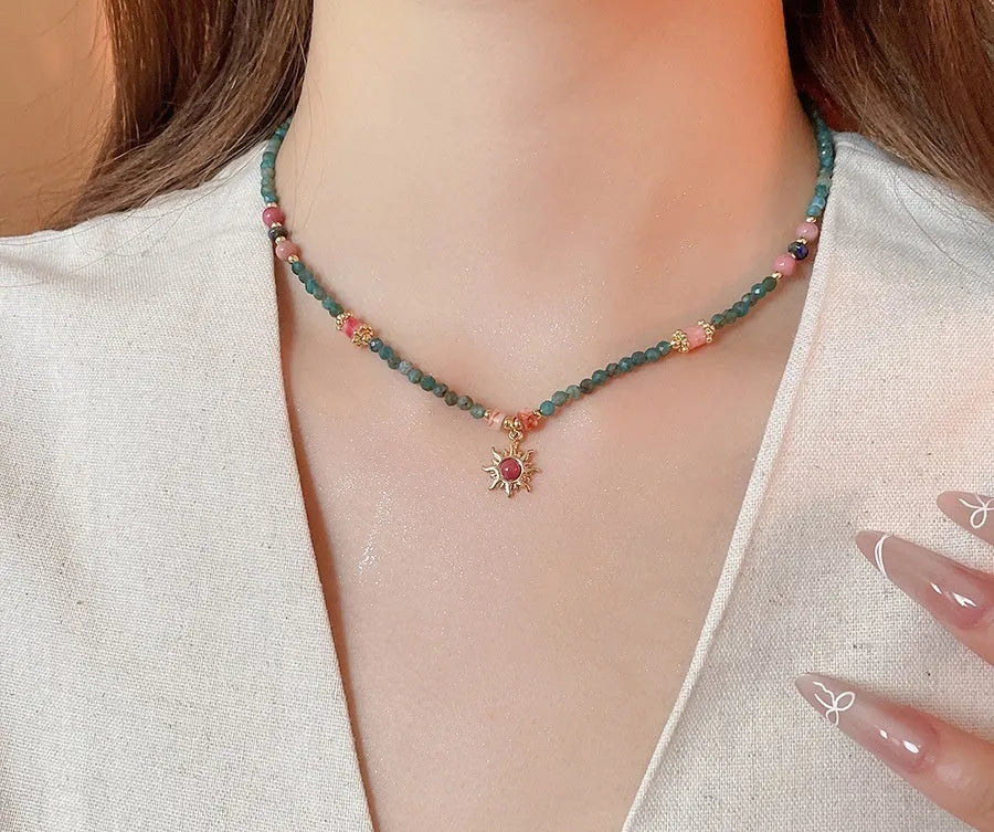 Freshwater pearl necklace with stone sun pendant on adjustable clavicle chain in blue and golden pink colours