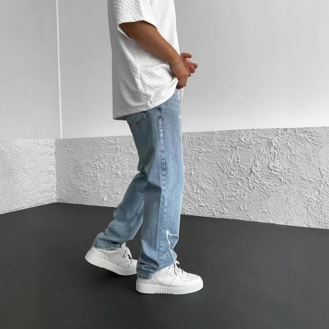 Men's blue straight-leg denim trousers with mid waist and zipper fly on neutral background