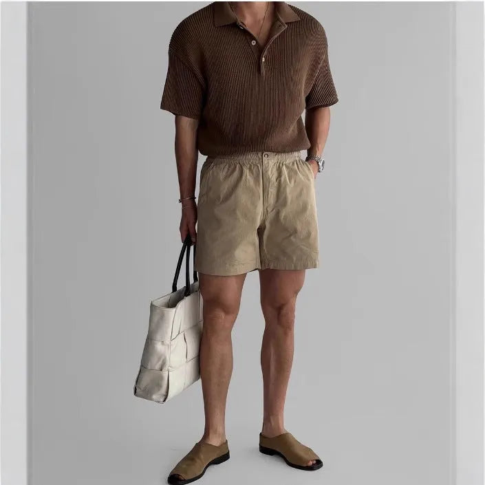 Cotton loose-fit sports shorts in black, shown on a model, suitable for summer activities.