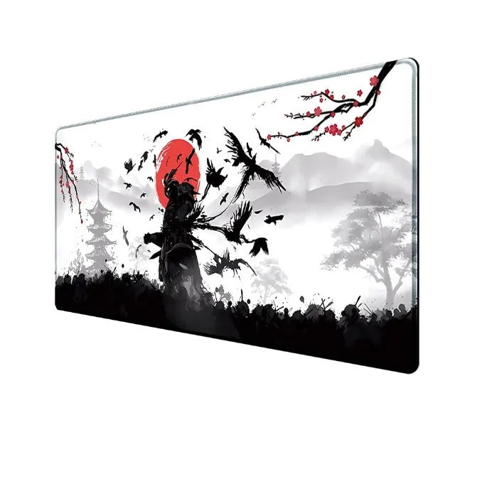 Japanese samurai design gaming mouse pad with cloth surface on a desk.