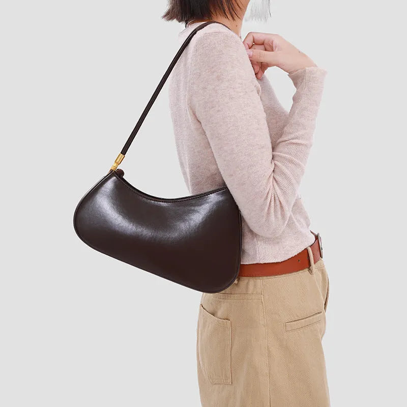 Retro oval women's underarm bag in PU leather with a single shoulder strap and zip pocket.