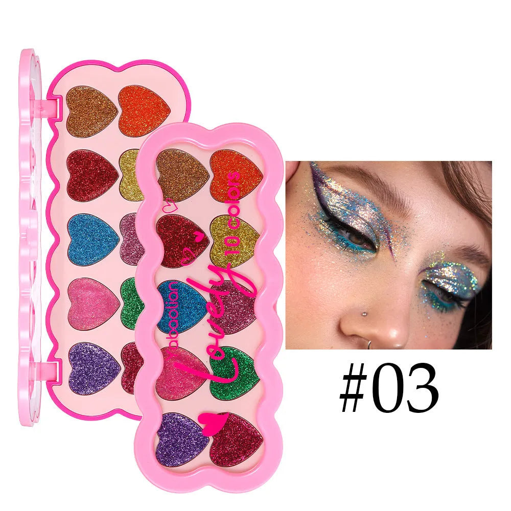 Pearlescent heart design eye shadow palette showing ten colours including white, beige, pink, purple, brown, blue, black, royal blue, maroon, and coral