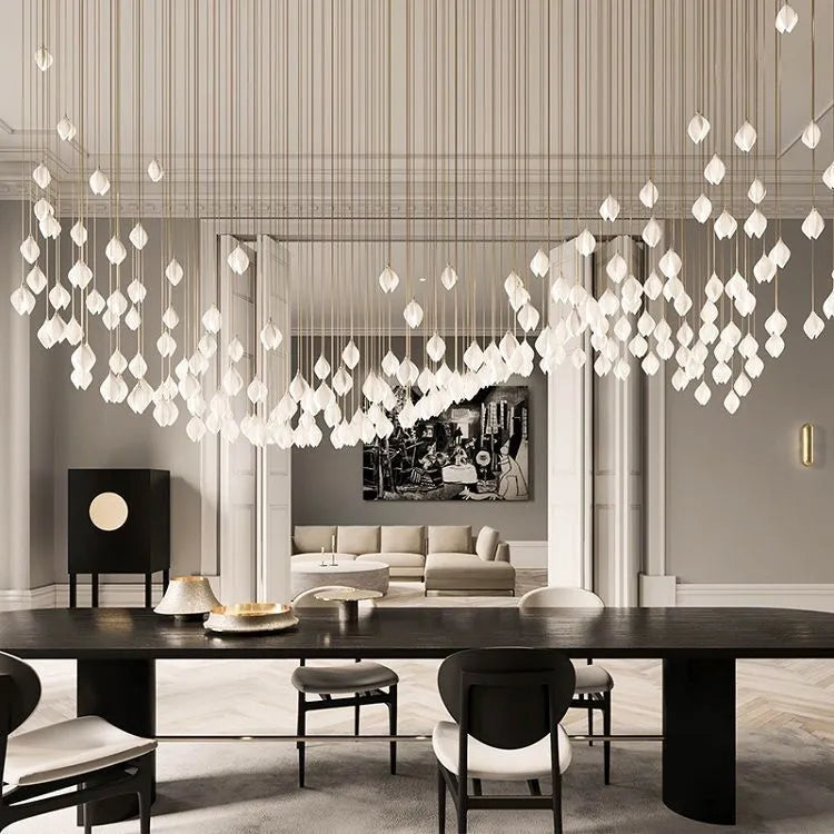 Ceramic magnolia flower-shaped single head pendant chandelier light with a dimmable bulb.