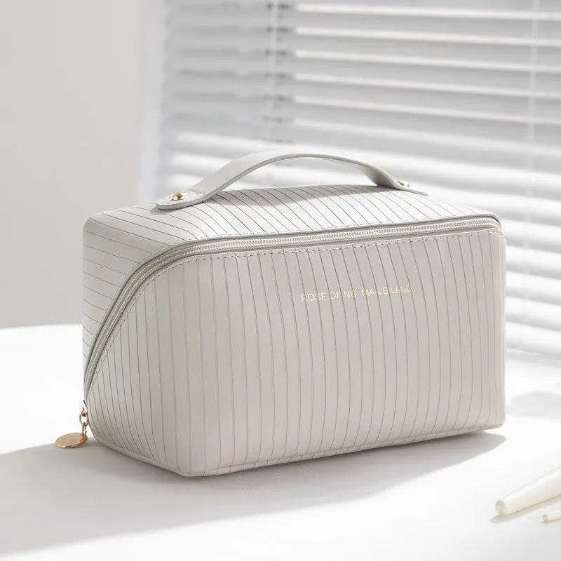 Vertical pattern pillow makeup bag in PU leather showing cubic shape and large storage capacity