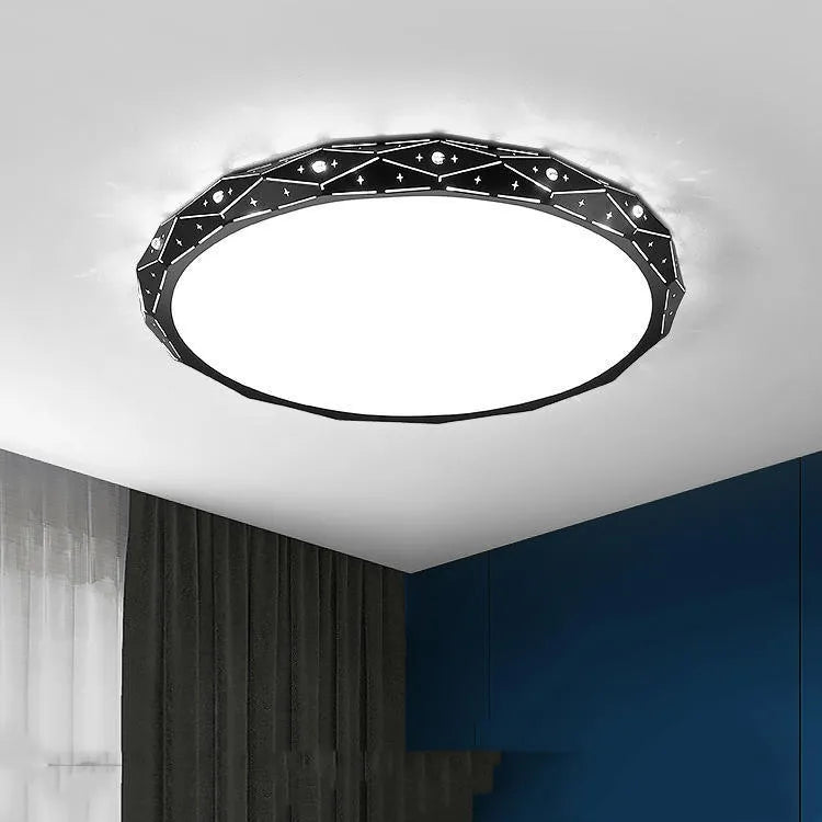 Round flush mount LED ceiling light with black iron frame on a white ceiling.