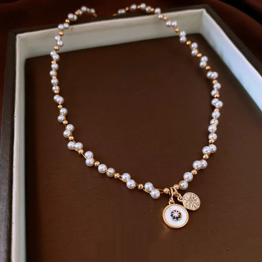 Women's gold electroplated round pendant necklace with zircon and imitation pearl on adjustable clavicle chain