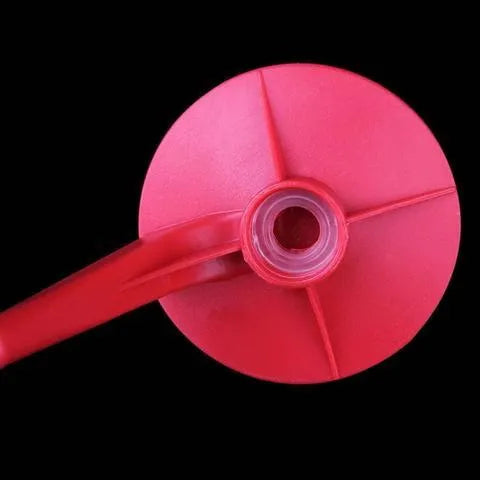 Red plastic Magic Tap soda bottle dispenser attached to a 2-litre bottle