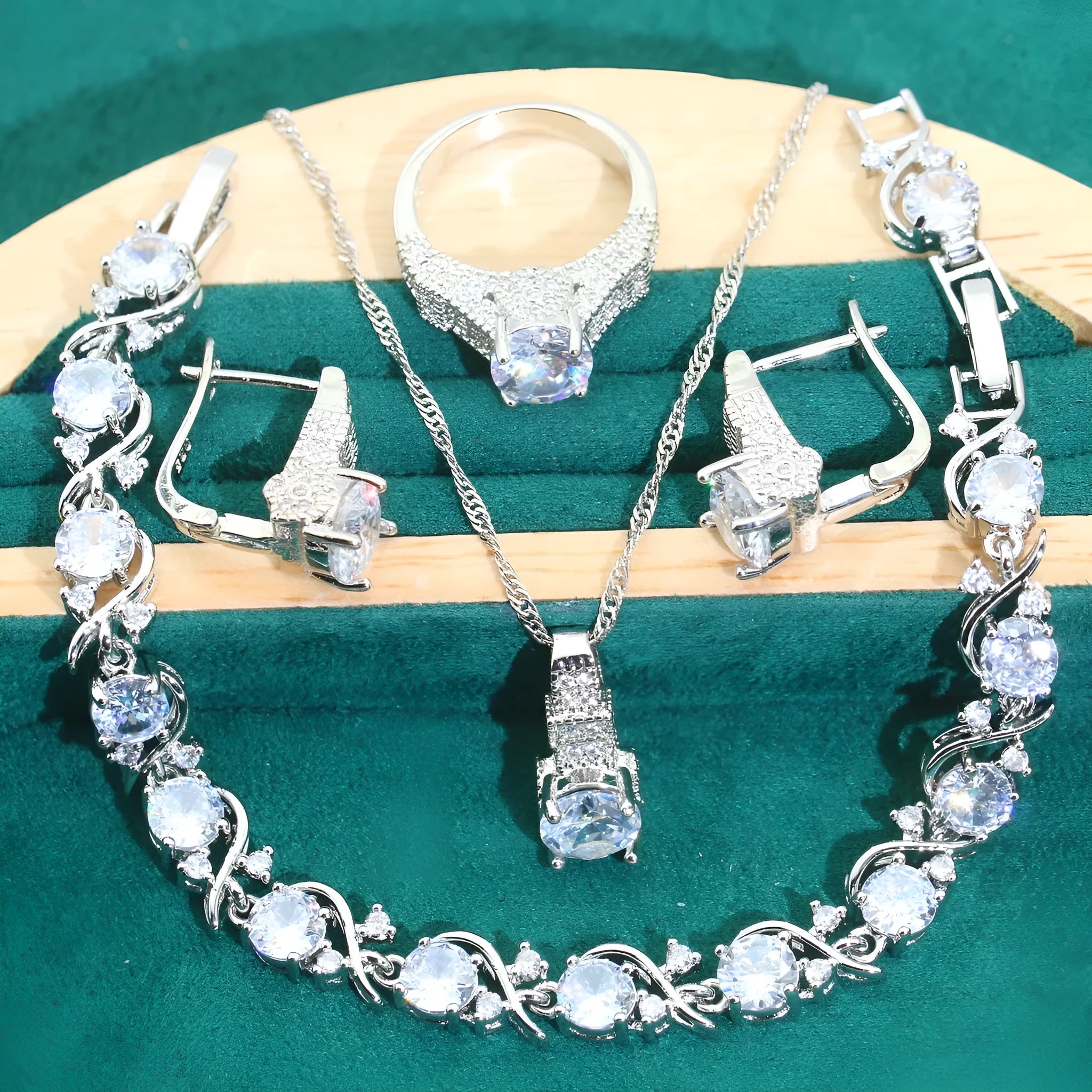Four-piece bridal jewellery set with water wave chain necklace, bracelet, earrings, and ring in alloy with zircon detailing