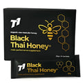 Glass jar of T1 Black Thai Honey showing dark black-coloured honey inside.