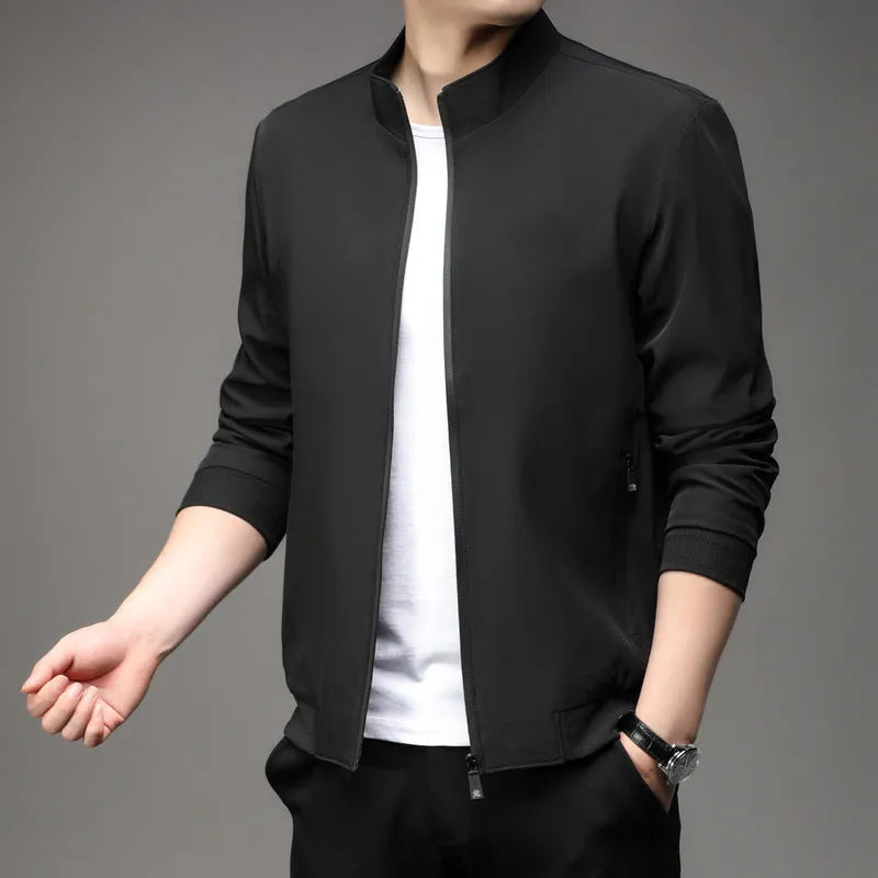Man wearing a loose-fit black lapel jacket, Korean-style casual autumn coat with zipper pockets.