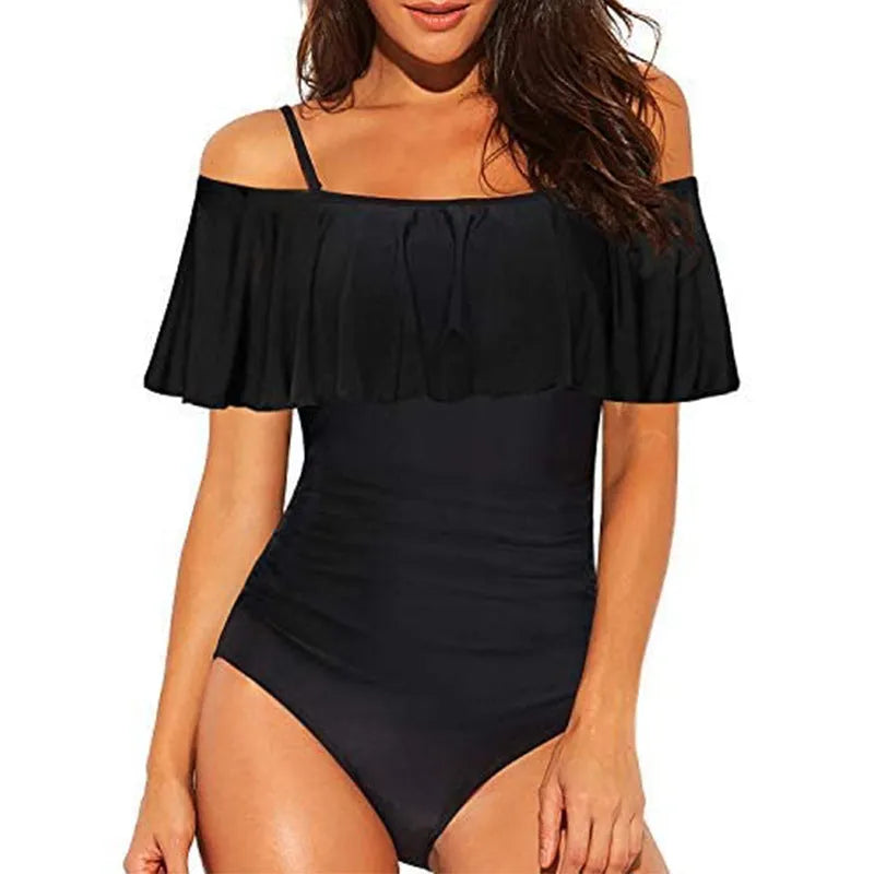 Black one-piece swimsuit with cut-out design and ruffled straps on the tube top.