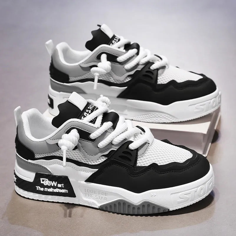 Men's low-top white board shoes with soft rubber sole and mesh lining on a plain background.
