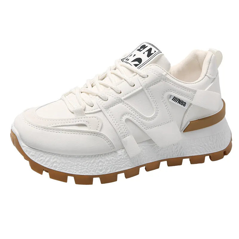Low-top white and black casual sneakers with round toe and lace-up front