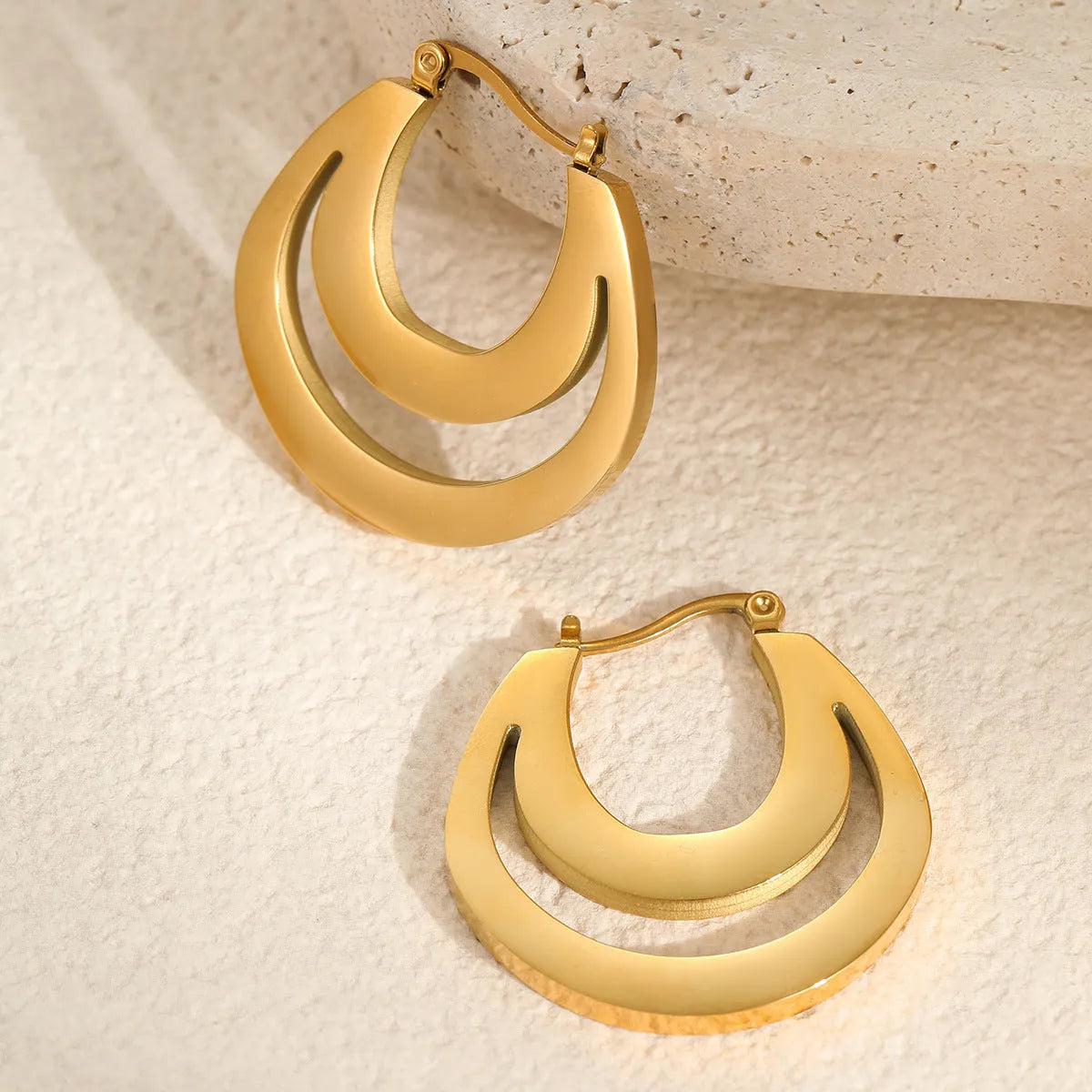 Geometric gold plated French earrings with round elements on stainless steel base
