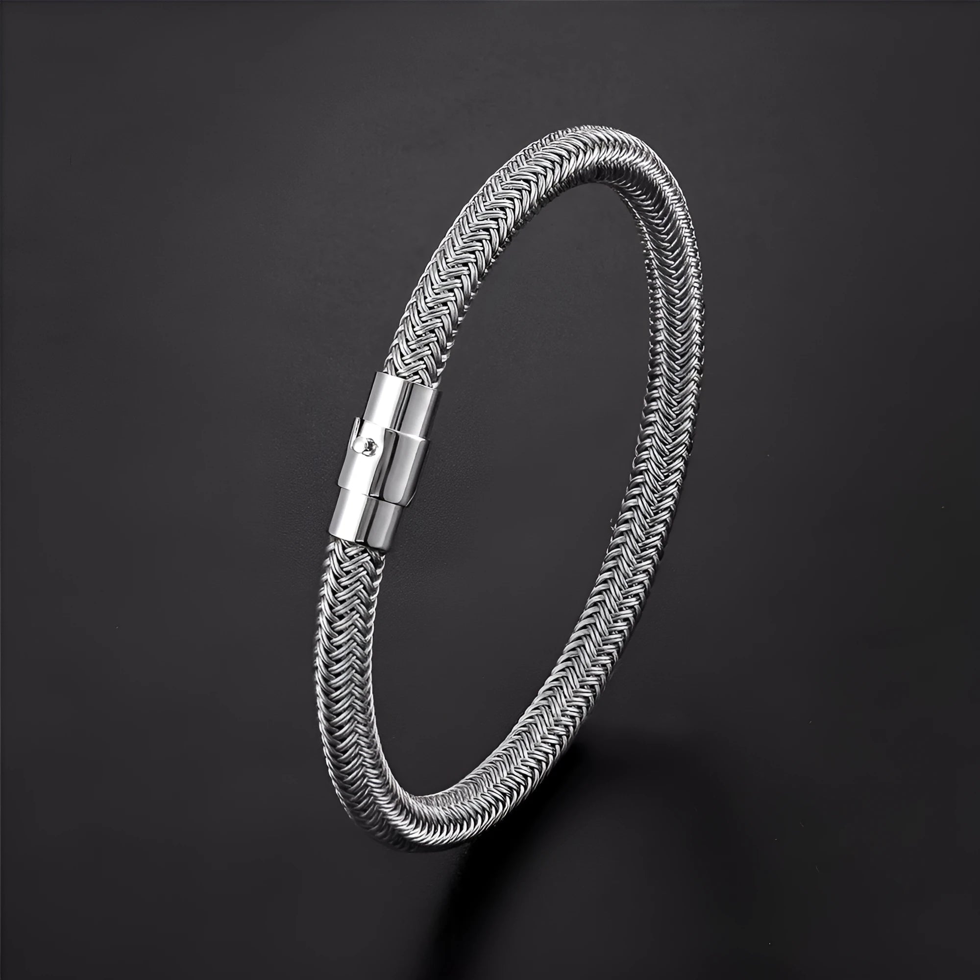 Titanium steel geometric wire bracelet with a magnetic clasp and charm socket.